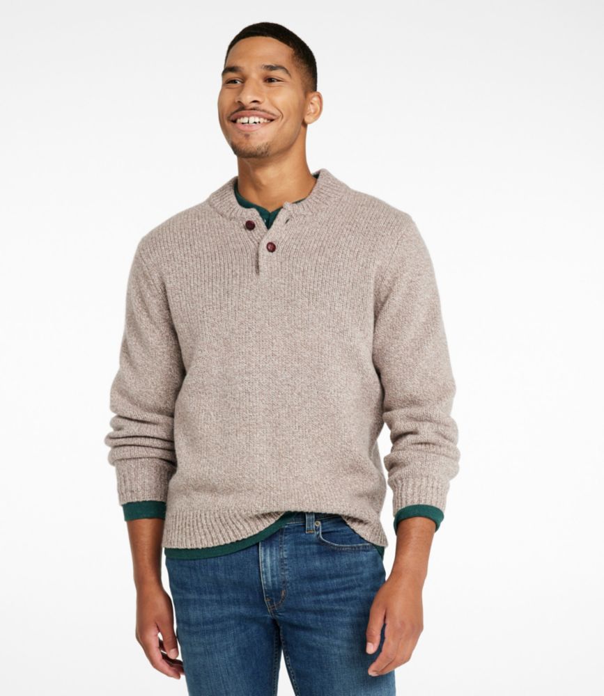 Men’s natural ragg wool Henley sweater with three-button placket, worn with blue jeans, front view.