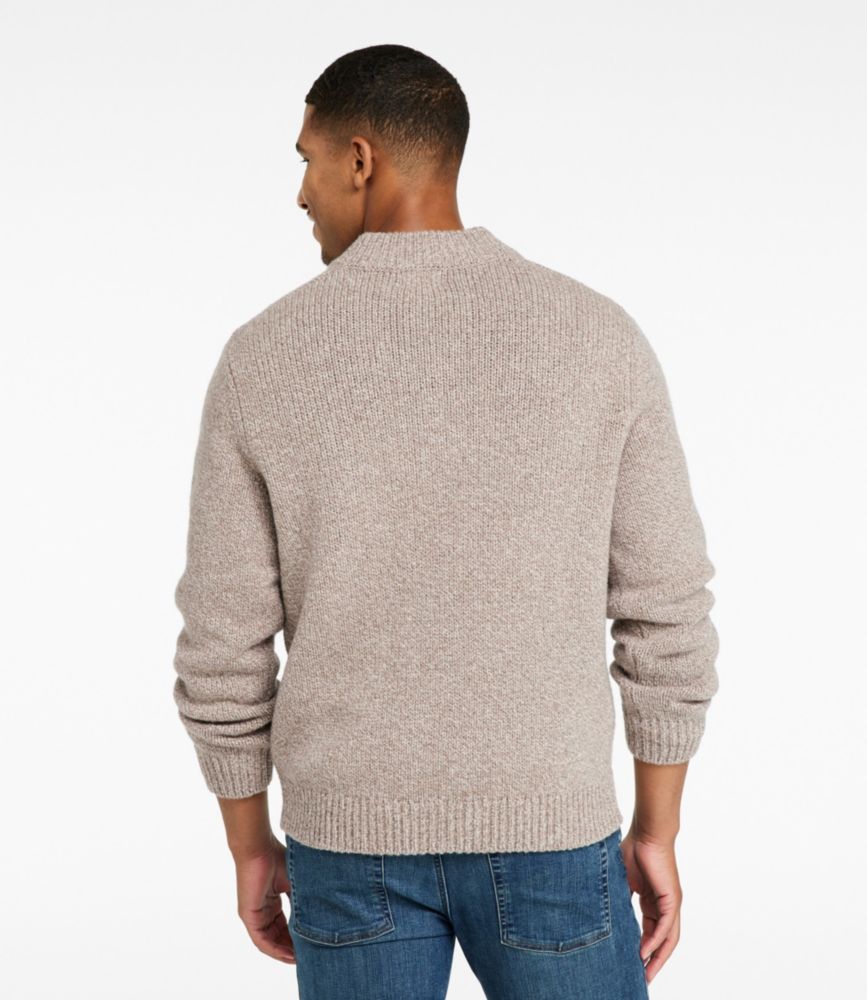Back view of men’s natural ragg wool Henley sweater with ribbed hem and cuffs, worn with blue jeans.