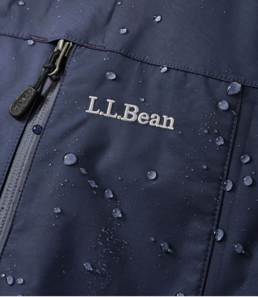 Close-up of navy L.L.Bean men’s parka front showing waterproof fabric with water droplets and zipper detail.