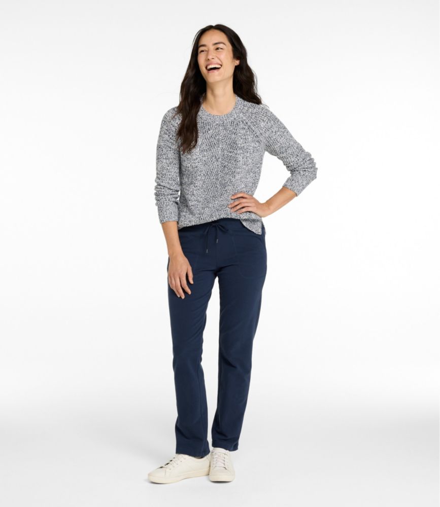 Women’s navy straight-leg sweatpants with drawstring waist, shown worn with sneakers.