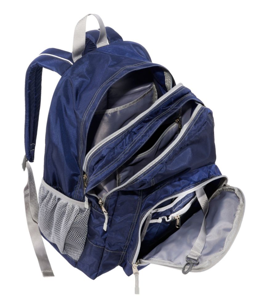 Navy blue school backpack with multiple zip compartments open and mesh side pocket, shown at an angle.