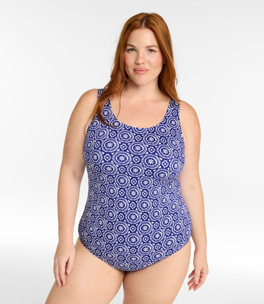 Women’s plus scoopneck one-piece swimsuit in blue and white circular medallion print, shown on model front view.