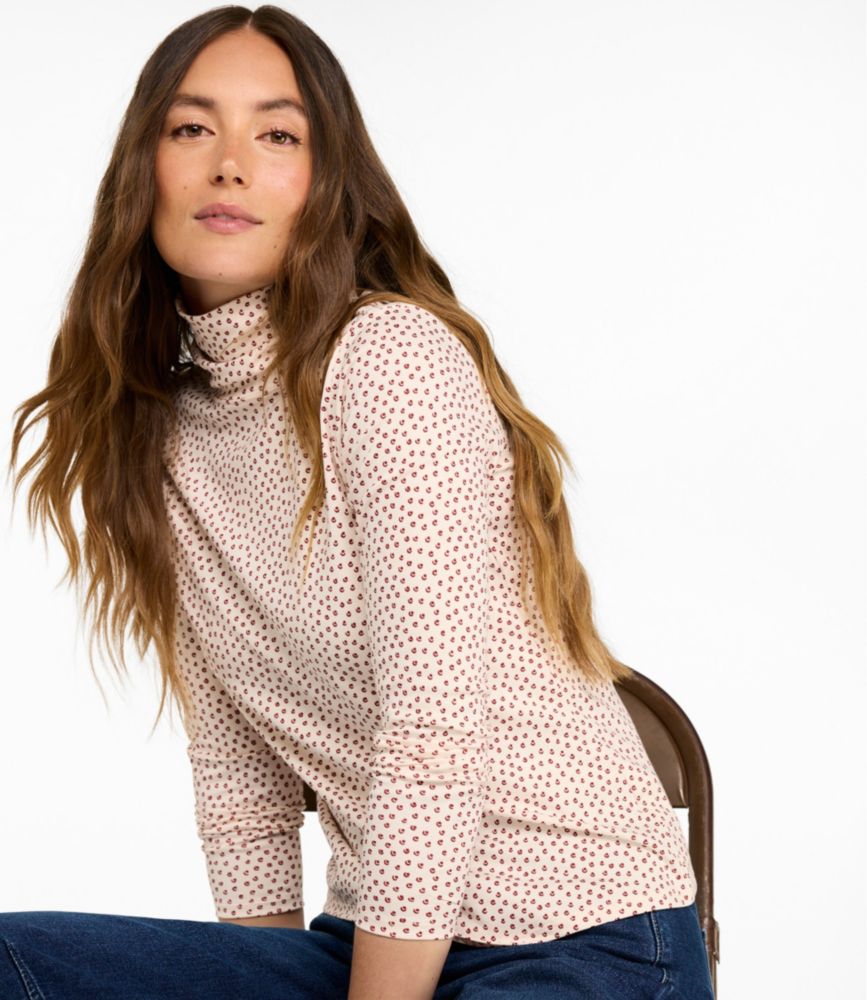 Women’s dark blue printed pima cotton turtleneck with white scatter dots, worn with light khaki pants.