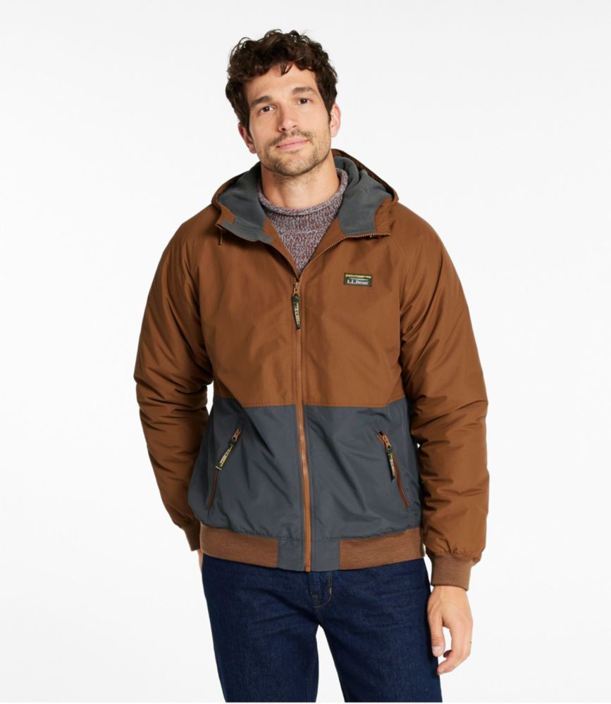Men’s colorblock hooded bomber jacket in brown and gray, front view on model over a sweater and jeans.