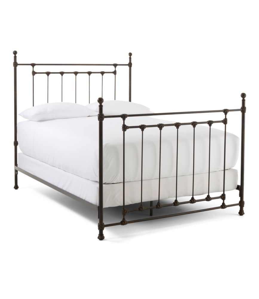 Rustic bronze king iron bed with vertical rod headboard and footboard, shown with white bedding on a white background.