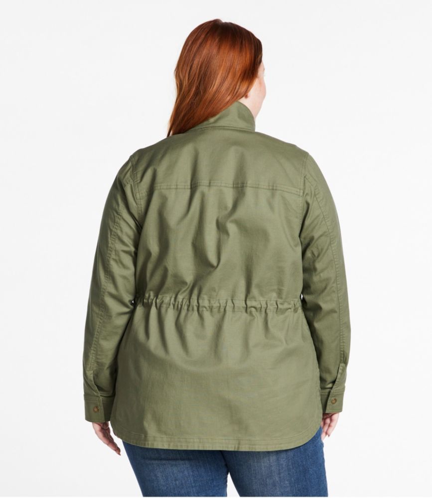 Back view of women’s plus olive utility jacket with cinched waist, worn over jeans.