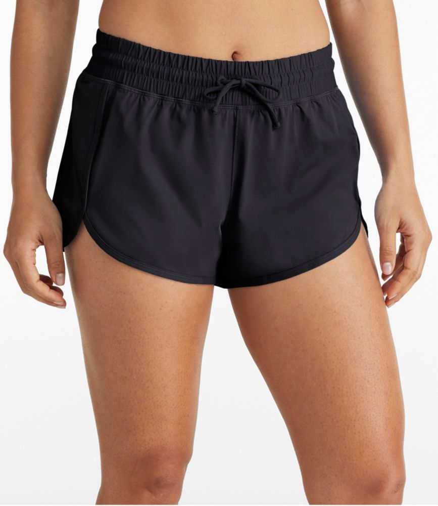 Women’s light blue knit swim shorts with elastic drawstring waist and curved hems, shown worn front view.