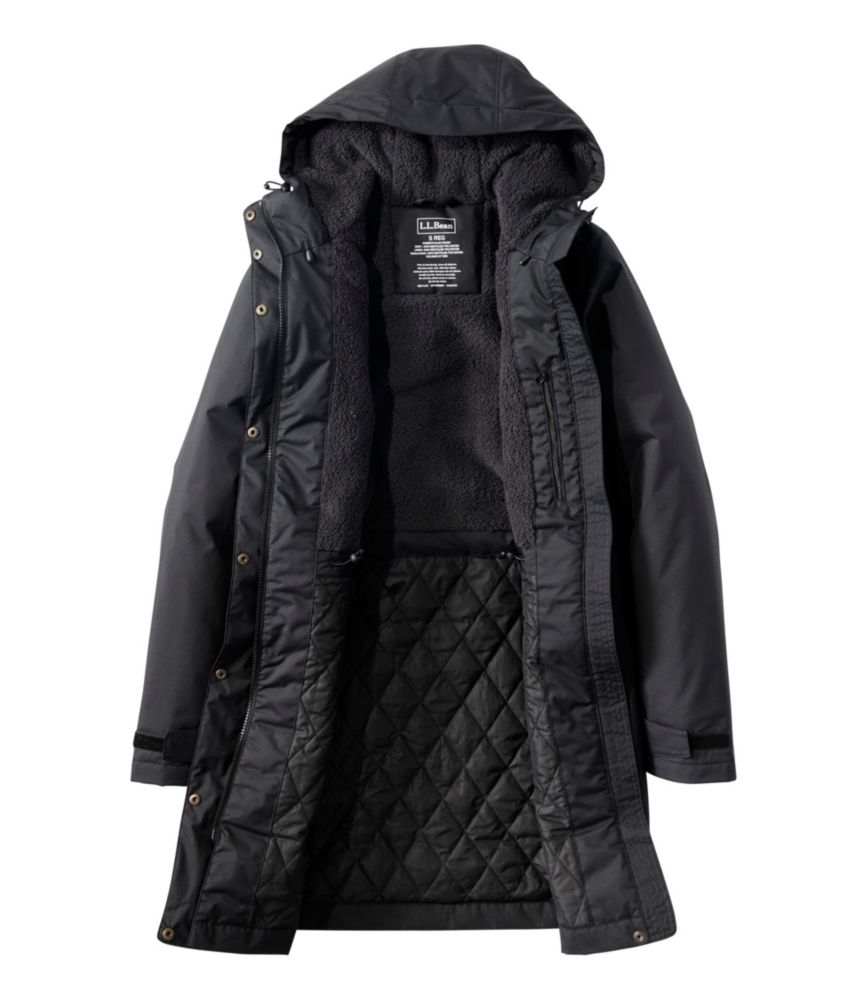 Women’s black hooded winter coat laid open to show fleece upper lining and quilted lower interior.