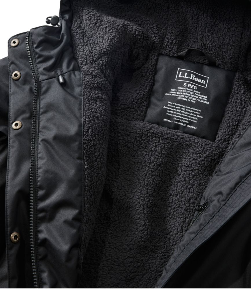 Black women’s winter coat detail showing plush dark fleece lining and interior label.