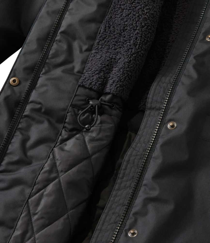 Black women’s winter coat detail showing quilted interior, sherpa fleece lining, zipper and drawcord waist.