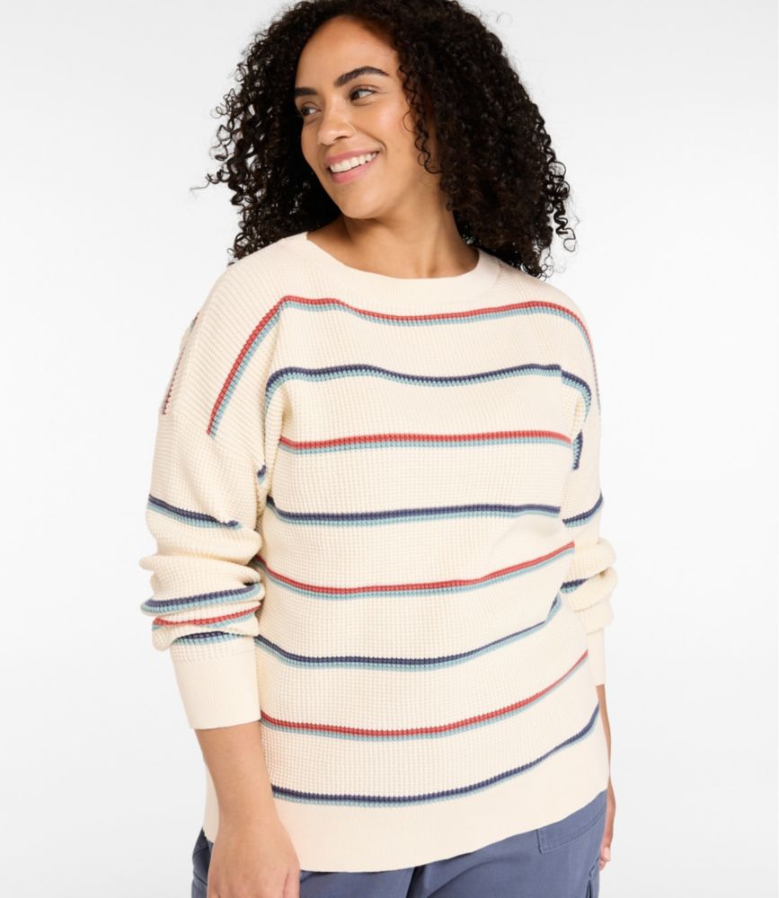 Women’s cream waffle knit pullover sweater with blue and red horizontal stripes, shown on model from the front.