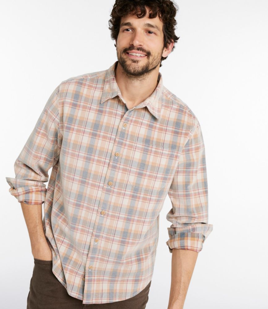 Men's mineral blue and beige plaid corduroy long-sleeve shirt worn untucked, sleeves rolled, front view.