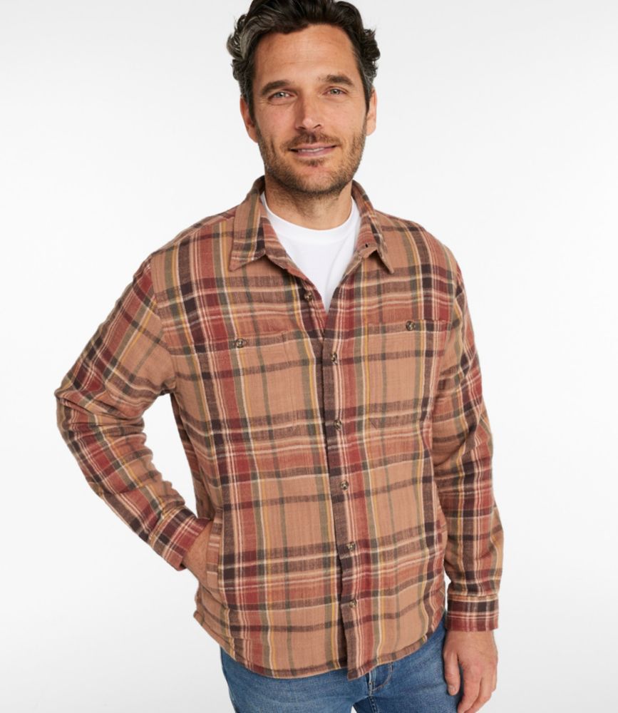 Men’s brown plaid flannel button-front shirt with chest pockets, worn over a white tee and jeans.