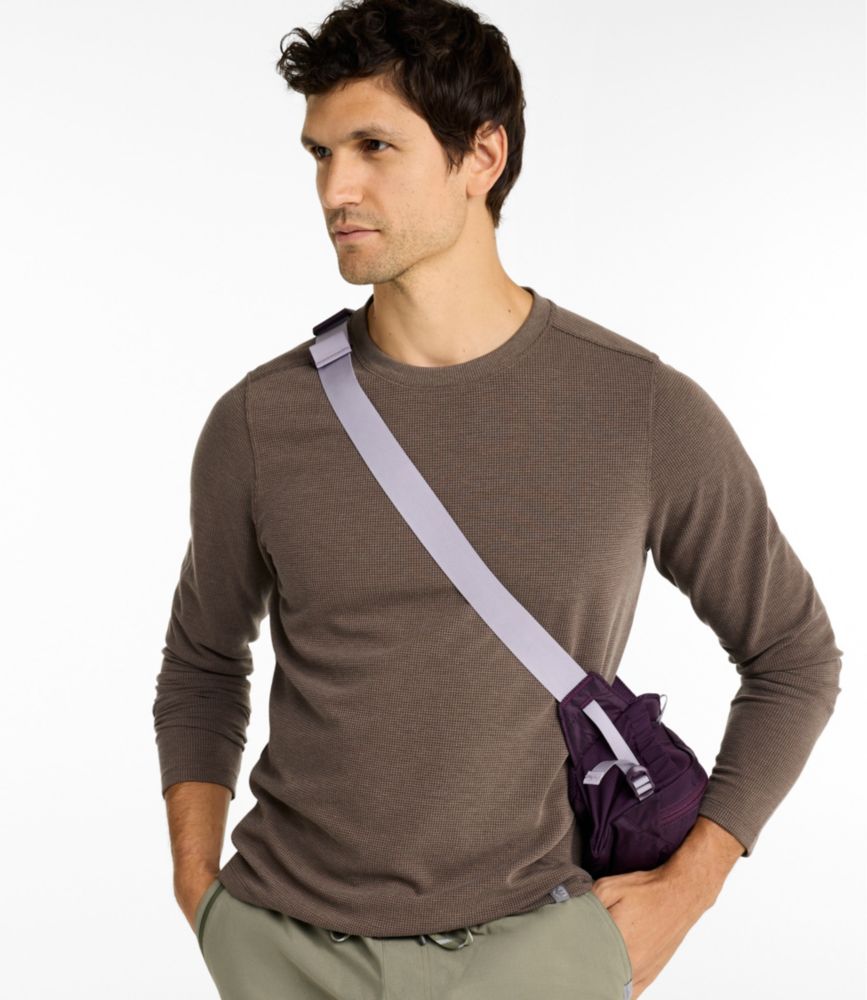 Men’s light blue long-sleeve waffle crewneck shirt worn by a model with one hand in olive pants pocket.