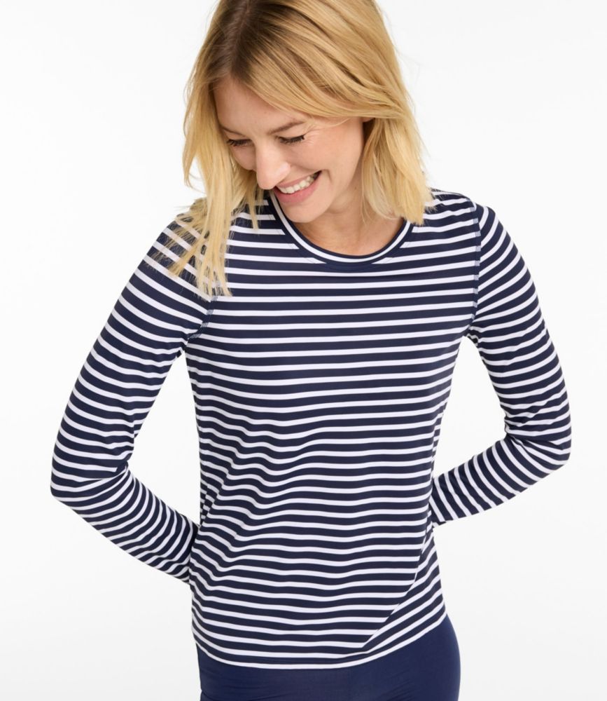 Woman wearing a navy and white striped long-sleeve SunShirt, shown from the front against a plain background.