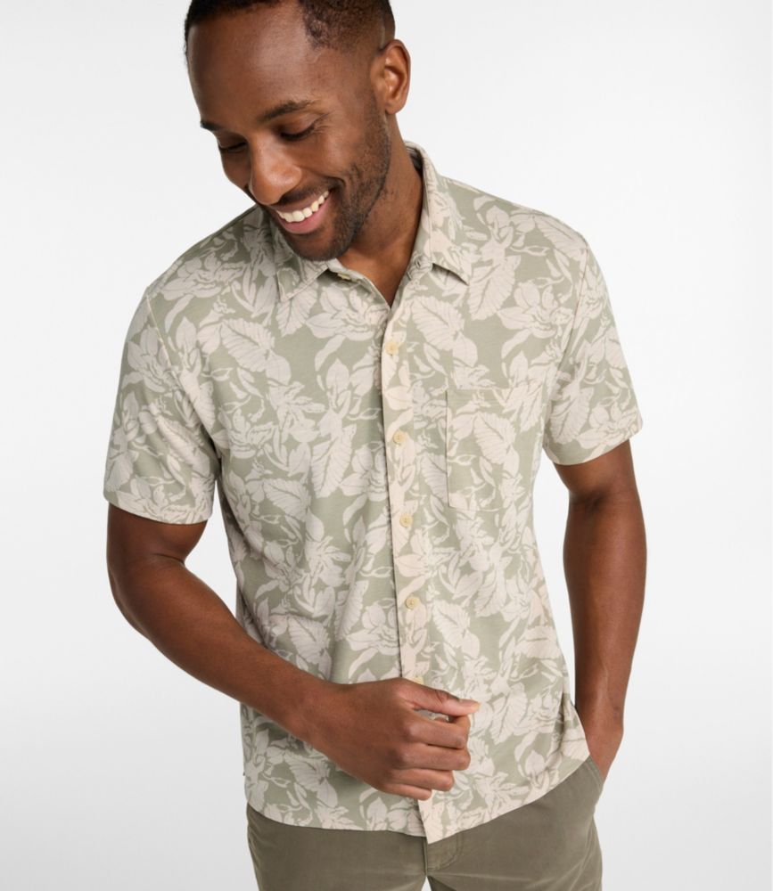 Men’s short-sleeve button-front shirt in light green and cream floral print, shown worn from the front.